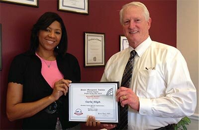 Rockdale County MIS Applications Analyst and ITIL Implementation Project Manager Carla Sligh celebrates the Honorable Mention recognition with Director Jim Howell.